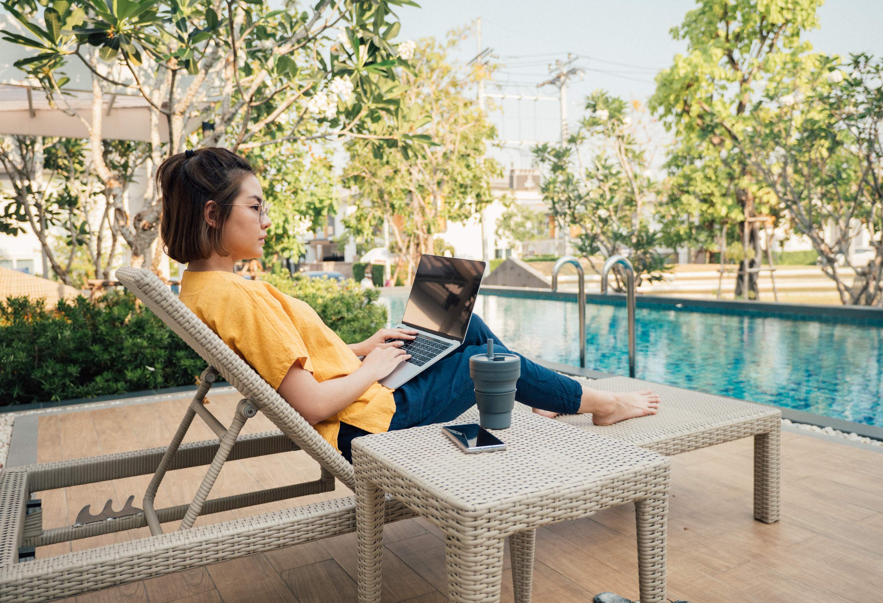 theme_people_device_pool_remote_working_sustaianble_hotel_travel_gettyimages-1215310022